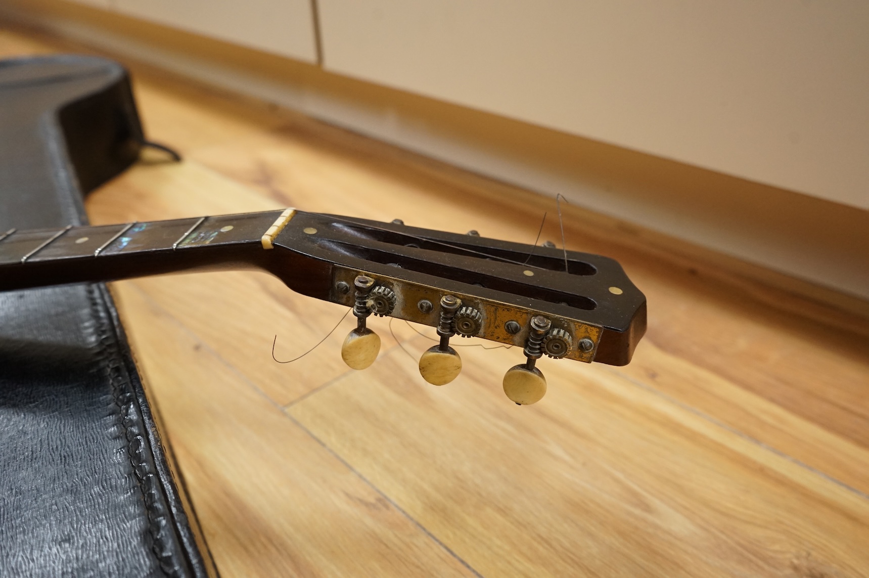 A rosewood banjo with mother of pearl inlay, cased